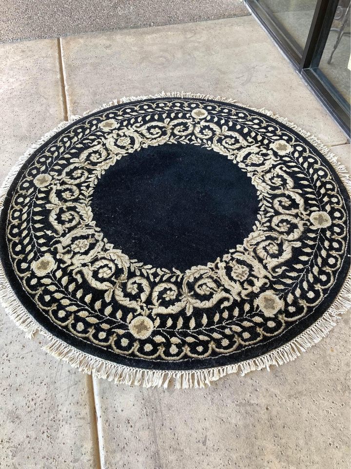 Round Black and Tan Rug